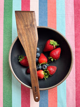 Load image into Gallery viewer, walnut handcrafted spatula pictured with a bowl of strawberries and blueberries
