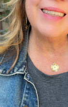 Load image into Gallery viewer, Flower pendant on a gold chain worn by a woman