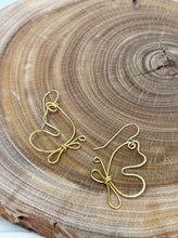 Load image into Gallery viewer, Gold butterfly earrings on a wooden surface