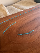 Load image into Gallery viewer, Close-up of black walnut serving board showing wood grain and crushed turquoise inlays.
