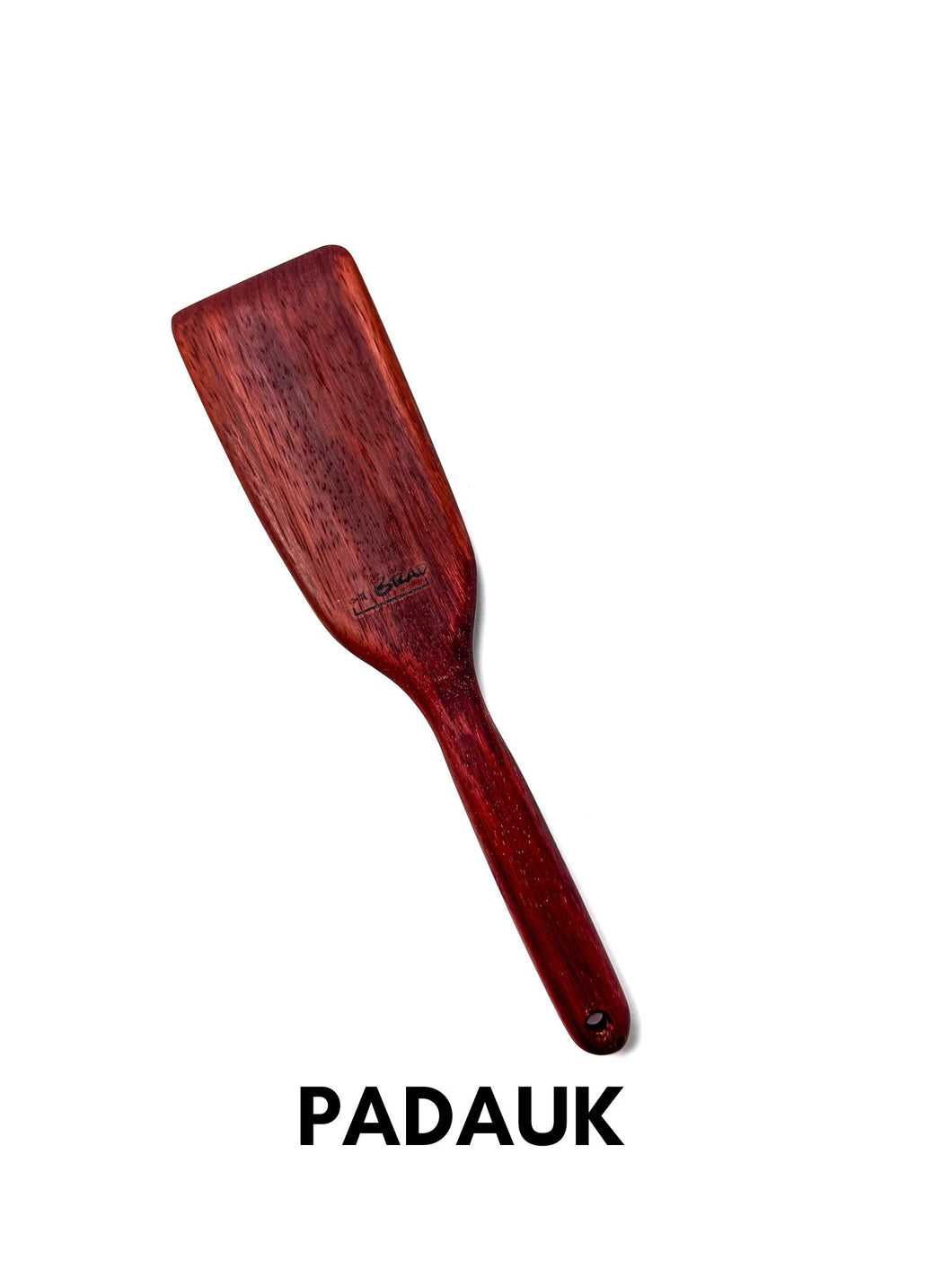 handcrafted wooden kitchen untensil in padauk wood on a white background