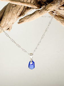 Tiny Sea glass pendant in blue on a sterling silver chain