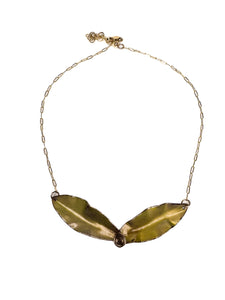 Necklace with two gold leaves joined at the center. Made of torch fired enamel with a gold filled chain