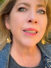 Load image into Gallery viewer, Flower drop earrings in brass worn by a woman

