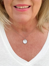 Load image into Gallery viewer, Small circle pendant necklace on a model
